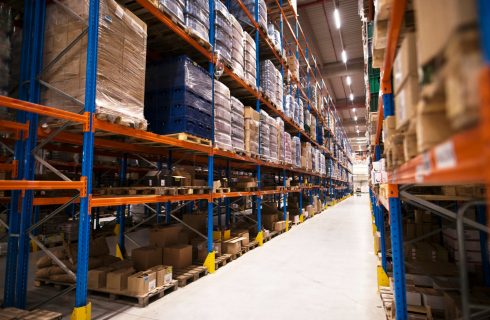 interior-of-large-distribution-warehouse-with-shelves-stacked-with-palettes-and-goods-ready-for-the-market